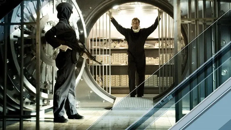 A masked figure standing in the round doorway of a bank vault in Inside Man