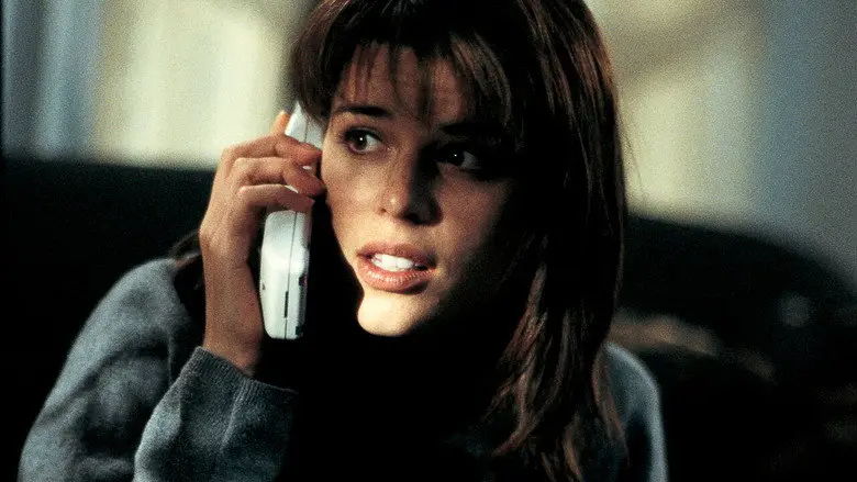 A frightened woman holding a white telephone in a dim room