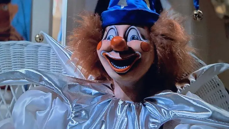 A brightly painted clown doll posed in a wicker chair