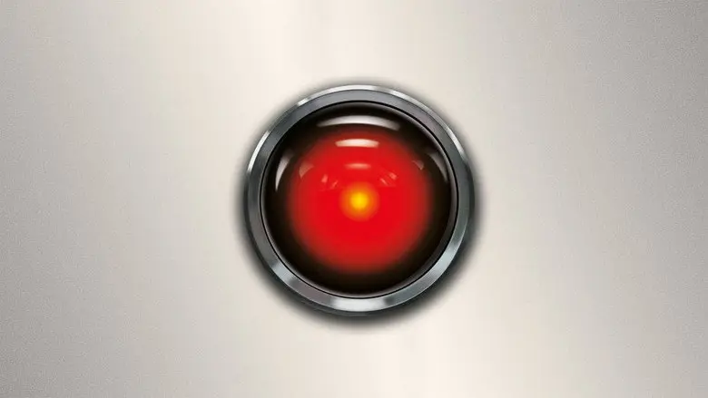 HAL 9000’s glowing red camera lens set into a pale control panel in 2001: A Space Odyssey