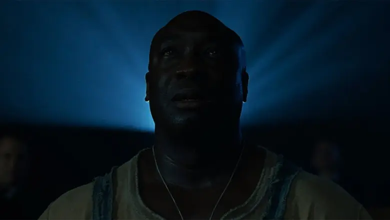 John Coffey stands in blue shadow in The Green Mile