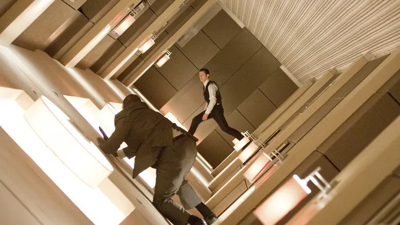 Two people moving through a tilted hotel corridor in Inception
